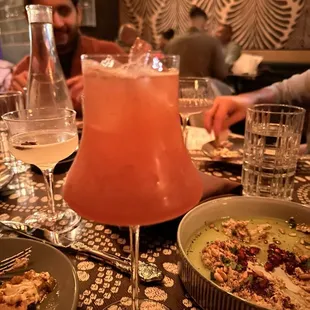 a man sitting at a table with food and drinks