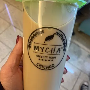 a person holding a glass of milk