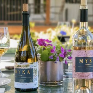 three bottles of wine and two glasses of wine