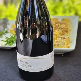 a bottle of wine and a plate of food