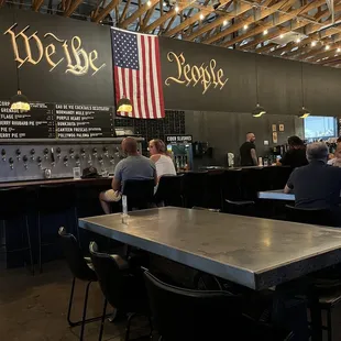 people sitting at tables in a restaurant