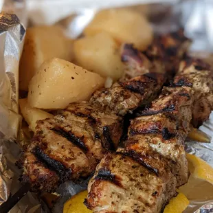 Pork souvlaki plate with lemon orzo soup and Greek potatoes