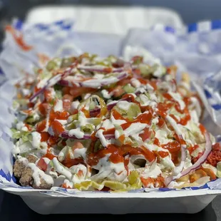 Mykonos Fries~ The lamb &amp; chicken was tender &amp; flavorful, topped with Tzatziki &amp; hot sauce to add a nice hint of spice to the loaded fries!