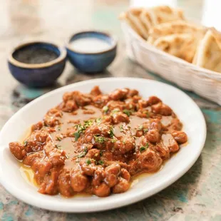 Greek style baked beans with tomato sauce ,olive oil and herbs.
