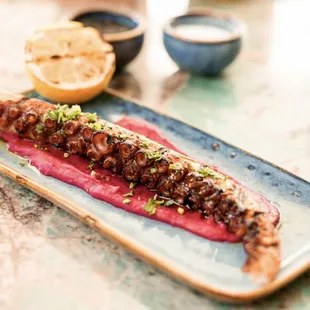 Sous vide and grilled cooked techniques Spanish octopus with lemon oregano.