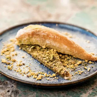 Mykonos Baklava- cripsy phyllo with pistachio,homemade syrup and topped with [istachio powder