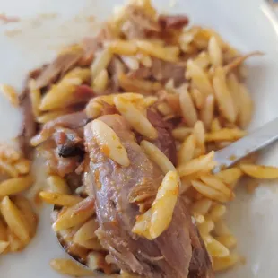 a plate of pasta with meat and cheese