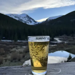 a pint of beer on a deck