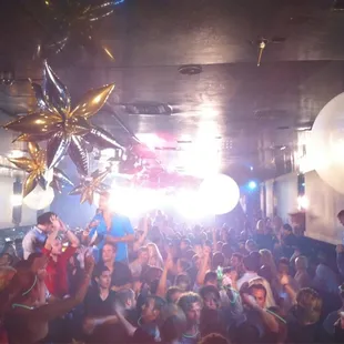 a large group of people dancing in a club