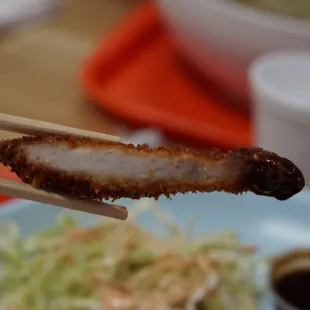 a piece of meat on a chopstick