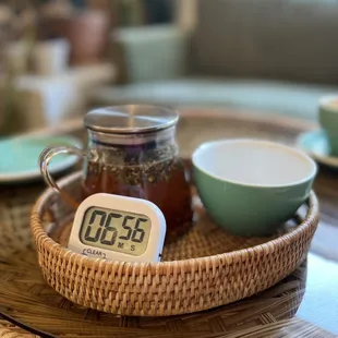 a wicker tray with a clock on it
