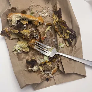 a half eaten sandwich and a fork