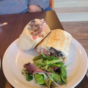 a plate of salad and a sandwich