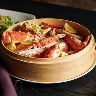 a bowl of crab salad and a glass of wine