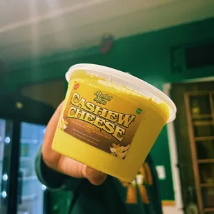 a person holding a cup of ice cream