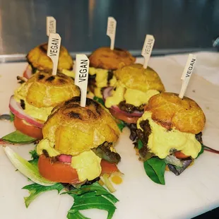 a variety of sandwiches on a cutting board