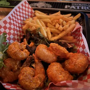 a basket of fried shrimp and fries