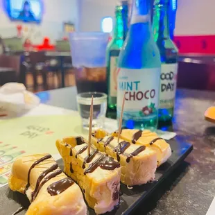 a plate of donuts with chocolate drizzle on them