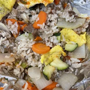 E21. Omelet Rice LMFAO $13-15 for uneven,oversized,undercooked vegetables swimming in a pool of grease.