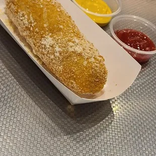 a hot dog on a bun with ketchup and mustard