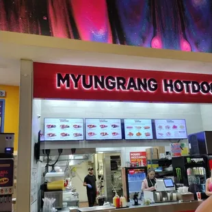 a woman eating a hotdog