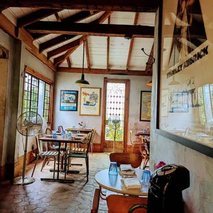 the interior of a restaurant with tables and chairs