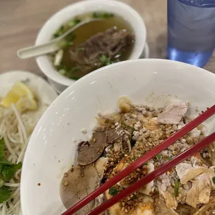 a bowl of noodles and chopsticks