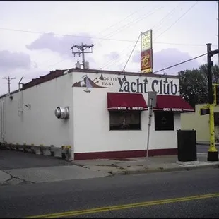 a white building with a red awning