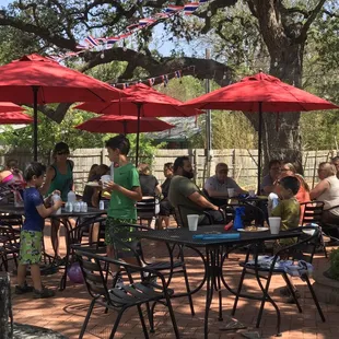a group of people sitting under umbrellas
