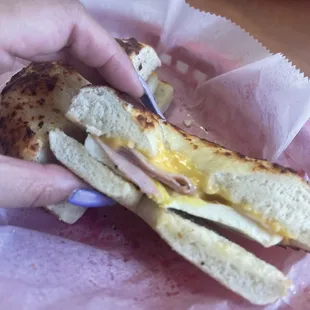Egg, ham, and cheese on a toasted Asiago bagel. Barely any meat.