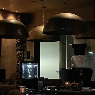 a living room with two lamps hanging from the ceiling