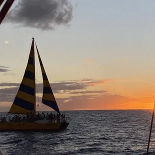 A sailboat against the sunset.