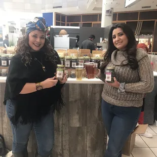 two women standing in a coffee shop