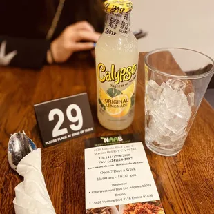  table with a menu and a glass of water