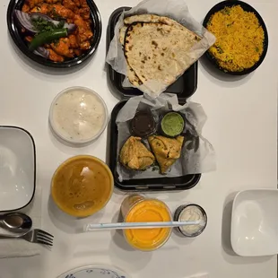 Chicken 65, garlic naan, vegetable with rice, Tikka masala, samosa and mango lassi