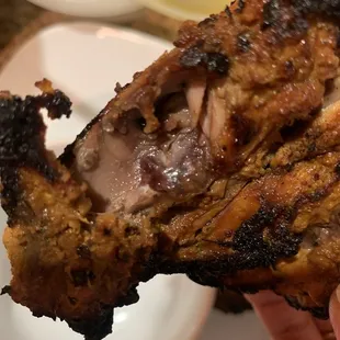 a hand holding a piece of meat