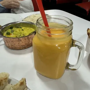 Mango Lassi with Madras Mixed Vegetable Curry in background. You can also seen part of the naan.