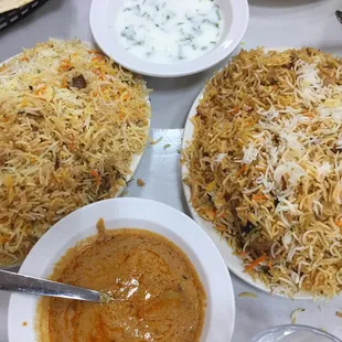 Mutton n chicken Biryani, Mirchi ka Salan( Gravy) and Raitha( white dish thats made of yogurt,cilantro and Onion)