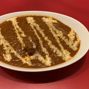 a bowl of soup with a striped pattern