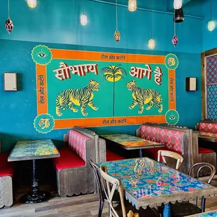 a colorful restaurant with tables and chairs