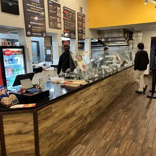 a man and a woman standing in front of a counter