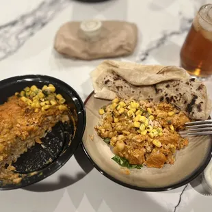 Chicken Tikka Masala Rice Bowl with half chana chickpeas, corn relish and cool chutney.  Cheese naan on the side.