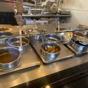 a variety of bowls of food in a kitchen