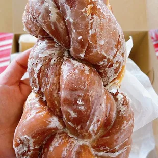 a hand holding a doughnut