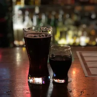 two glasses of beer on a bar