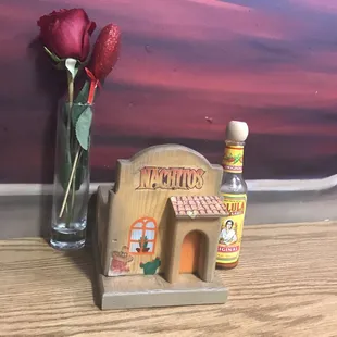 a bottle of liquor and a miniature house