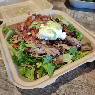 a salad in a styrofoam container