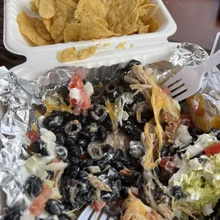 a plate of mexican food and a fork