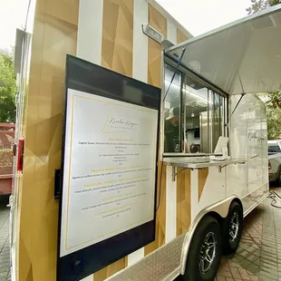 the food truck parked on the side of the road