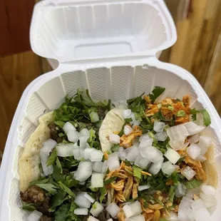 a close up of a taco in a styrofoam container